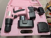 Pink cordless drill with two batteries and charger in pink case