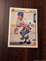 Front of the 1991-92 Upper Deck NHL hockey card showing Teemu Selanne in Finland white uniform and blue helmet skating with a hockey stick.