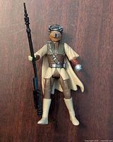 Front view of the Star Wars Princess Leia Boushh Disguise action figure holding staff, showing outfit details and helmet.