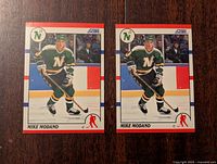 Front view of two identical Mike Modano rookie hockey cards in Minnesota North Stars uniform.