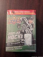 Photo of unopened Upper Deck 2021-22 Hockey Series Two box, front and top showing bonus pack inside and hockey player image.