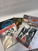 Five vinyl record albums shown overlapping, showcasing front covers from Bros, Beastie Boys, Georgia Satellites, Brownsville Station, and Crazy Cavan 'N' The Rhythm Rockers.