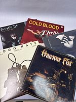 Photo showing all five vinyl record album covers together: Wreckless Eric, Cold Blood, Good Rats, Hanover Fist, and Roy Orbison.