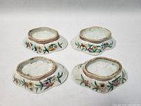 Set of four antique Chinese Famille Rose footed offering bowls shown from side profile to display painted decoration and footed base