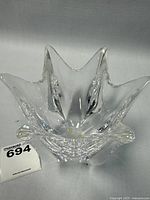 Top view of clear star-shaped crystal bowl showing the petal-like points radiating from the center and the smooth glass finish.
