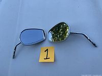 Two chrome motorcycle side mirrors with long angled stems and threaded attachment ends, displayed on a white background.