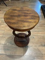 Top view of the round wooden end table showing smooth wood grain finish and circular tabletop.