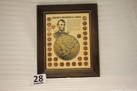 Full shot of the framed Lincoln Memorial penny display with 29 pennies surrounding a central image and text.