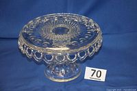 Front side angle view of the cake plate showing the lace apron edge and brandy well center.