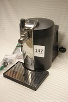 Front and side view of Krups beer tap with drip tray and tap handle visible