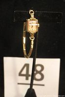 Full front view of the watch on stand showing case, dial, band.