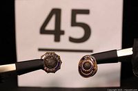 Two American Legion pins side by side including a gold Past Commander pin and a smaller non-gold pin, with a number 45 background.