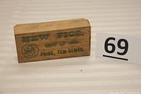 Top view of the small antique wooden box showing the printed text "NEW FIGS, CROP OF 1882, PRICE, TEN CENTS."