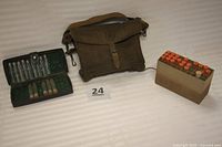 Brown thick fabric vintage medical bag, metal clasp, expandable bottom, showing front and strap