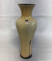 Full front view of beige Caithness Glass vase with flared rim and subtle black design at base; original label on body.