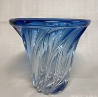 Front angle view of the heavy blue art glass vase showing swirl pattern and flared rim.