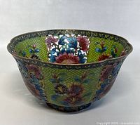Full front view of scallop-edged bowl showing floral plique-à-jour enamelwork with green background.