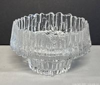 Front view of vintage clear textured glass bowl/candle holder with scalloped rim and thick glass base.