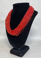 Full view of the multi-strand necklace displayed on a black bust to show length and style.