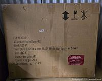 Cardboard box containing a framed mirror. Box details show the item as MCS industries framed mirror 18x24 White Woodgrain with Silver, item 83041, made in China.