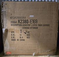 Damaged cardboard box packaging for the Homepop faux leather storage ottoman showing item number and weight details.