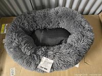 Top view of the gray plush cozy pet bed showing its circular shape and raised edges.