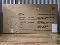 Cardboard box packaging with product details, item is an end table in knotty oak color, made in Malaysia, weight about 8-9 kg.