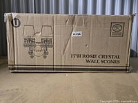 Cardboard box showing product illustration, 17-inch height, Rosie Crystal Wall Sconces label.