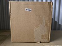 Closed cardboard box with label M 030 likely containing the cat bed tent inside.