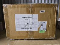 Sealed cardboard box labeled Jaipur Living with product model and shipping details, showing the item is new and packaged.