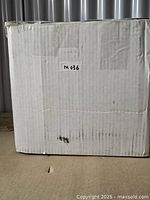 White cardboard box with label M036 containing the flush mount light fixture, no original retail box visible.