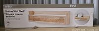 Box packaging showing the full shelf and product name Anko Rattan Wall Shelf, new condition with labeled dimensions.