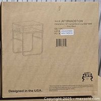 Cardboard box showing item name and illustration of the 18 inch side table with curved metal legs and wooden surface in grey wash.