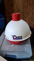 Photo of Big Bobber Floating Cooler with visible branding and colors showing white top, red bottom and cap with carrying handles
