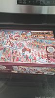 Box of Cobble Hill 2000 piece Santa Parade puzzle showing holiday parade scene