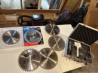 Full view of the set on a white surface showing all saw blades and storage case.