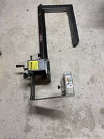 Top-down view of the Brett-Guard table saw safety tool showing metal frame, adjustment knobs and clear safety shield.