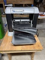 Front view showing infeed table, cutterhead area and overall condition