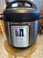Front view of Instant Pot Duo Plus 6 quart electric pressure cooker showing control panel and lid handle.