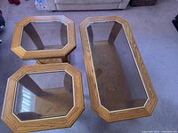 Top view of the rectangular coffee table and two octagonal end tables showing glass inset tops and oak frames.