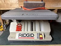 Front view showing base, control switch, Ridgid logo and disc storage slots