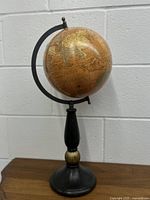 Full view of 8 inch terrestrial globe on its black metal stand, showing overall condition and structure.
