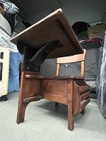 Side view showing cast iron tilt mechanism, oak frame and integrated seat