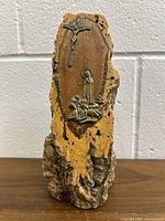 Front view of olive wood trunk with mounted bronze crucifix and Our Lady of Fatima with the three children at the base.