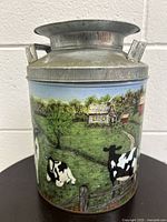 Full view of tin container showing detailed painted farm scene with cows on the side and metal lid on top