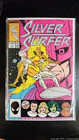 Front cover of Silver Surfer #1 comic book showing main characters and Marvel branding, with close-up on the issue number and price.