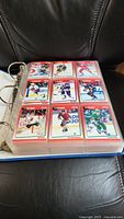 Binder page showing 9 hockey cards from the 1991 Score series, players in various NHL teams in action poses.