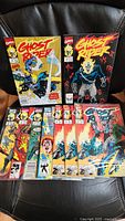 Photo showing all 9 Ghost Rider comics laid out, various cover art visible with bright colors and Ghost Rider character on motorcycle.