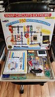 Box of Snap Circuits Extreme SC-750 electronic science kit showing front with project graphics and description of over 750 projects.