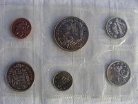 Six uncirculated Canadian coins in plastic sleeves. Includes penny, nickel, dime, quarter, half dollar and Manitoba commemorative dollar.